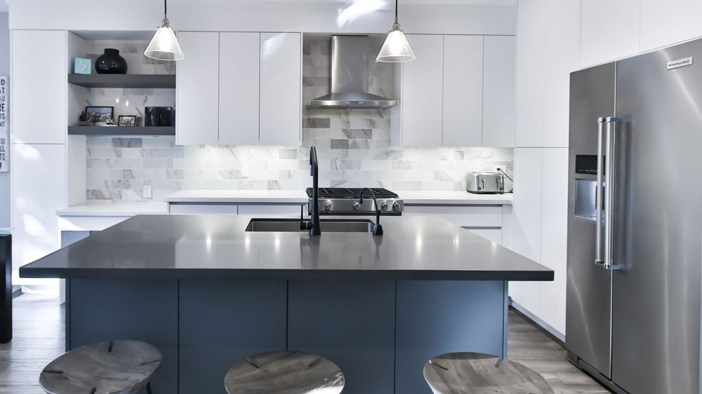 A bright, modern kitchen with a stainless steel refrigerator & ice maker