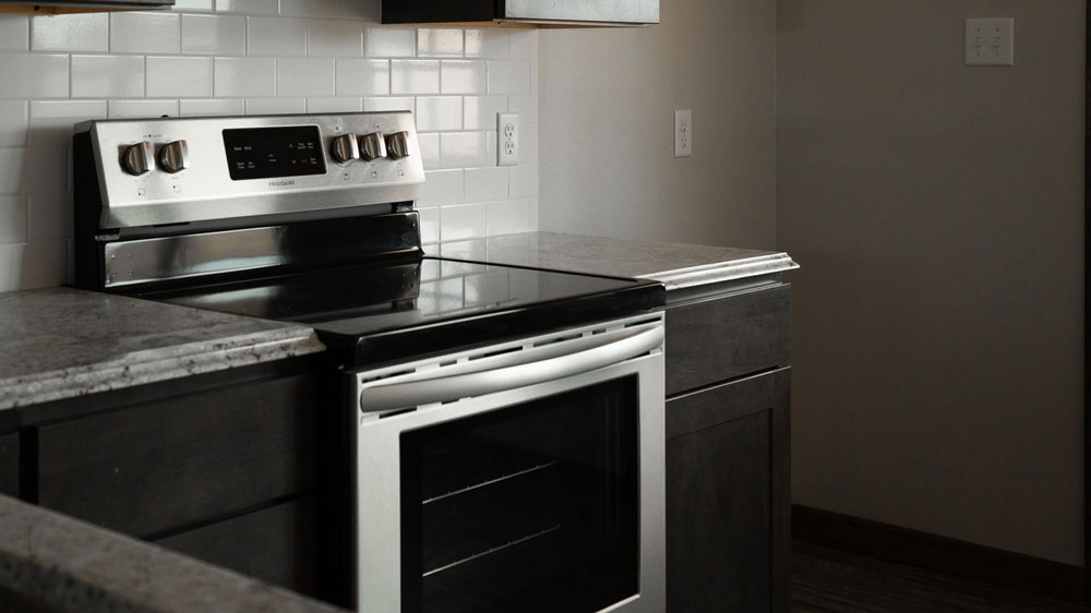 A kitchen with an oven and marble countertops